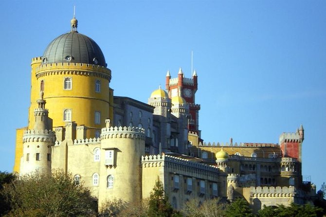 Sintra & Cascais Day Tour with Pena Palace Entry and Gardens Walk - Entering Pena Palace through the Sintra Hills