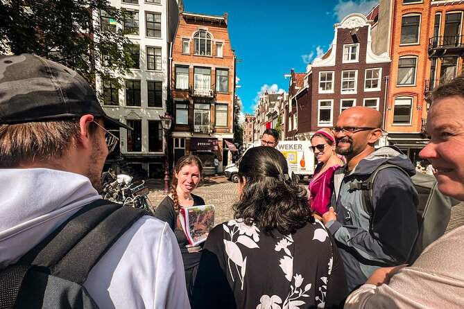 Small Group Walking Tour - Hello Amsterdam - Torensluis adds the canal belt and its harder history