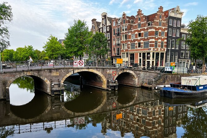 Small Group Walking Tour in Amsterdam with Friendly and Fun Guide - Dam Square and Damstraat: start with Amsterdam’s origin story