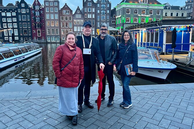Small Group Walking Tour in Amsterdam with Friendly and Fun Guide - The canal belt: one hour of water, trade, and change